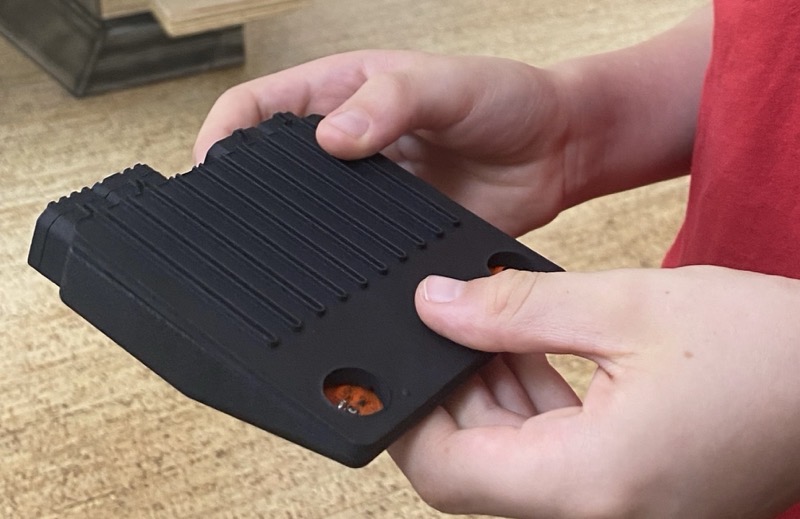 Kid's hands holding a multi-jet fusion-printed Pickup prototype