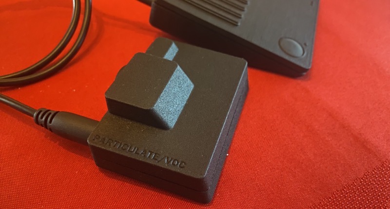 Final particulate module next to a Pickup on a red tablecloth.